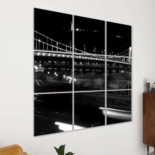 Night view of Elisabeth Bridge in Budapest with glowing streetlights, traffic light trails, and river reflections.