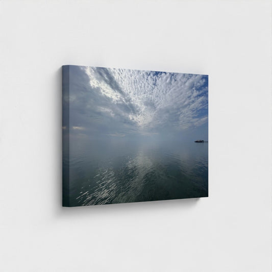 Eco-friendly canvas print of Blackpool seascape with layered clouds, calm water reflections, and a distant pier under a quiet sky.