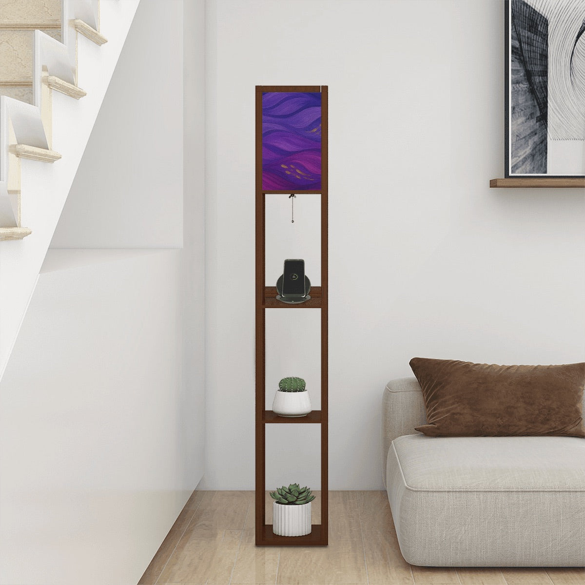 Walnut-finished wood floor lamp with three open square shelves—one holding a ceramic vase, another stacked books—and a linen cube shade featuring vibrant purple, magenta and gold wavy abstract patterns. A pull-chain switch and black power cord hang below.