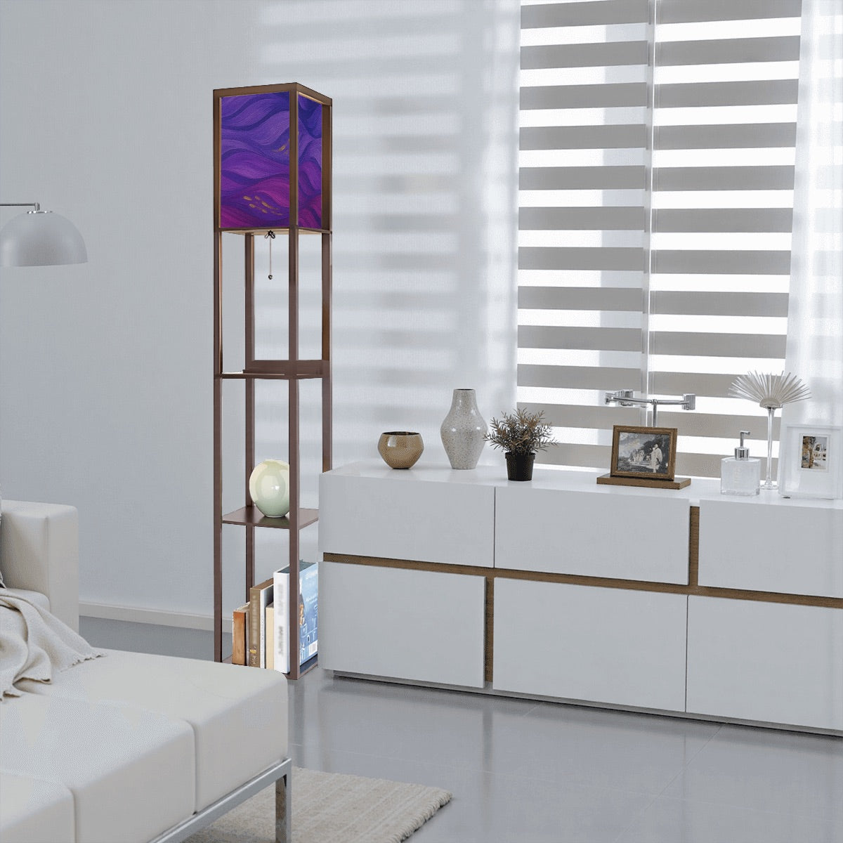 Walnut-finished wood floor lamp with three open square shelves—one holding a ceramic vase, another stacked books—and a linen cube shade featuring vibrant purple, magenta and gold wavy abstract patterns. A pull-chain switch and black power cord hang below.