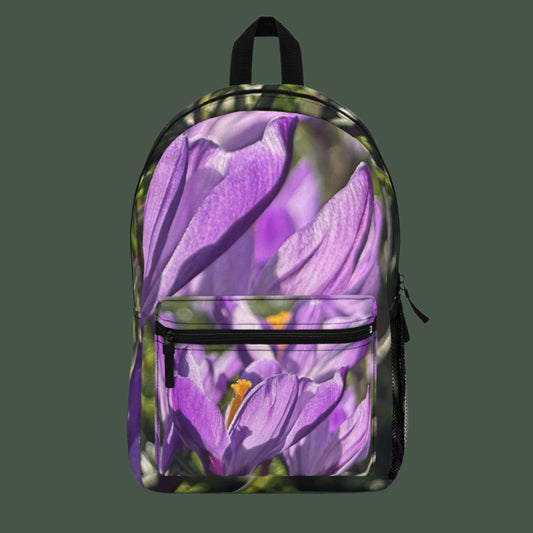 Front view of floral backpack with bold purple crocus flowers in full bloom, centered on the main panel.