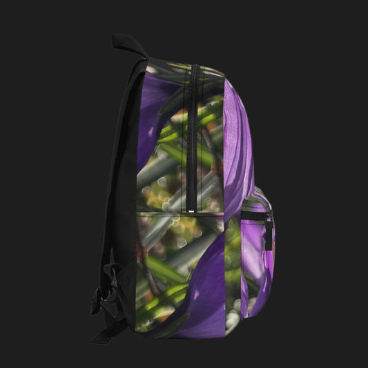 Left side of backpack showing purple crocus print wrapping around the side panel and bottle pocket.