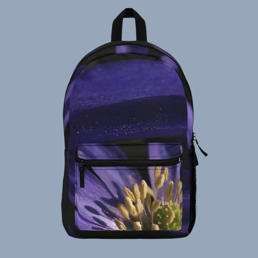 Front view of purple floral backpack with close-up anemone flower centered on the main panel.