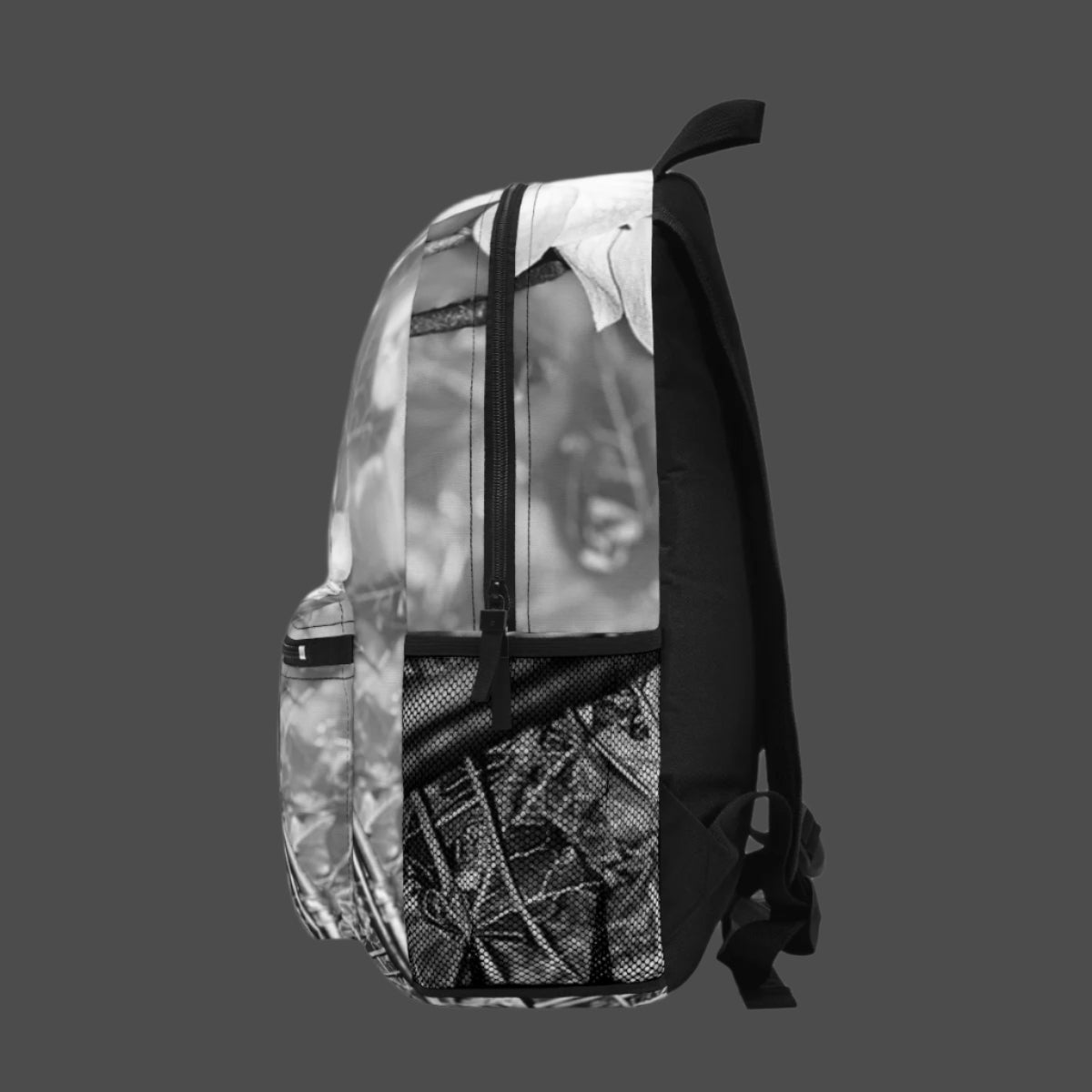 Right side view of backpack with black and white floral print and smooth zip closure visible.