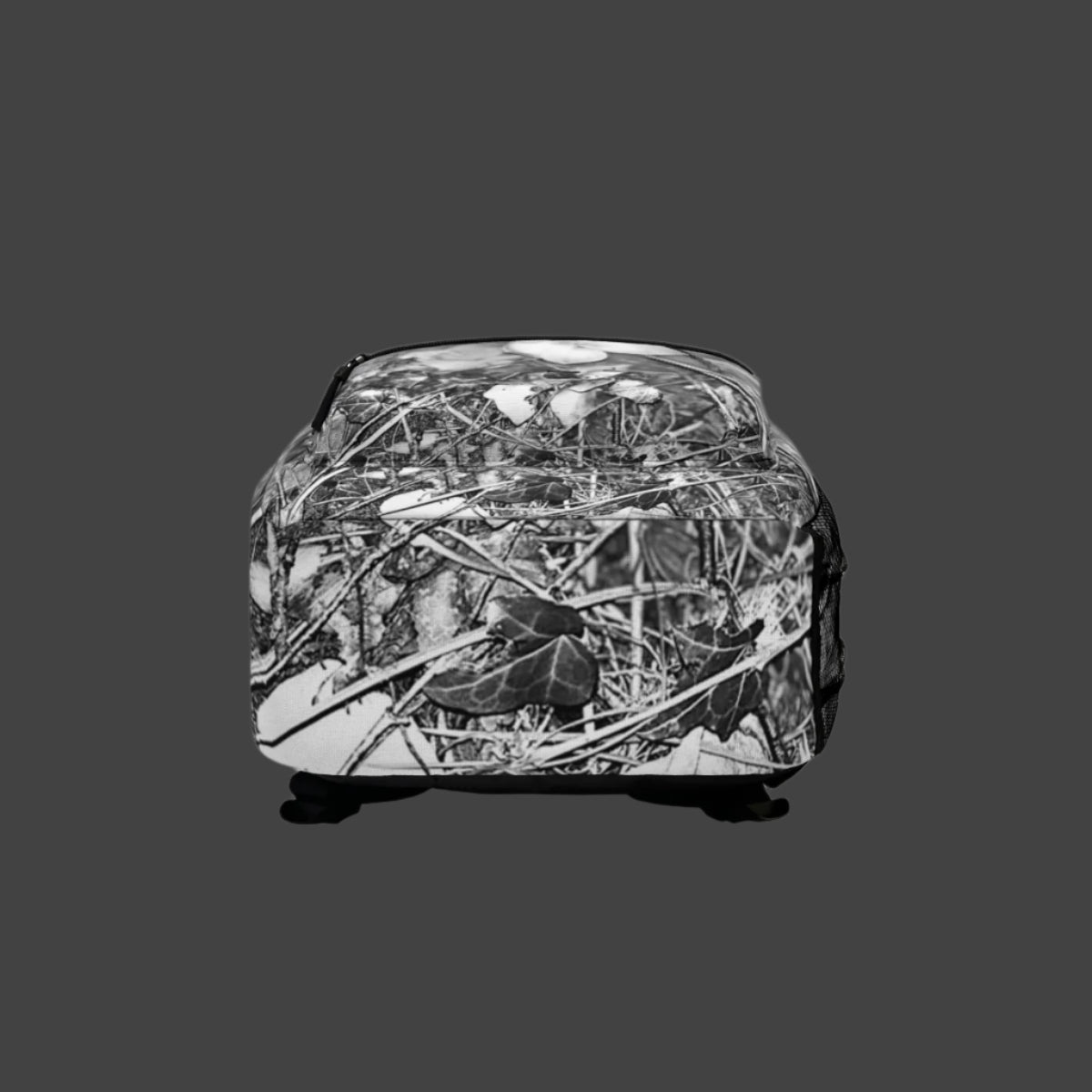 Bottom of backpack displaying reinforced stitching and continuation of black and white orchid flower design.