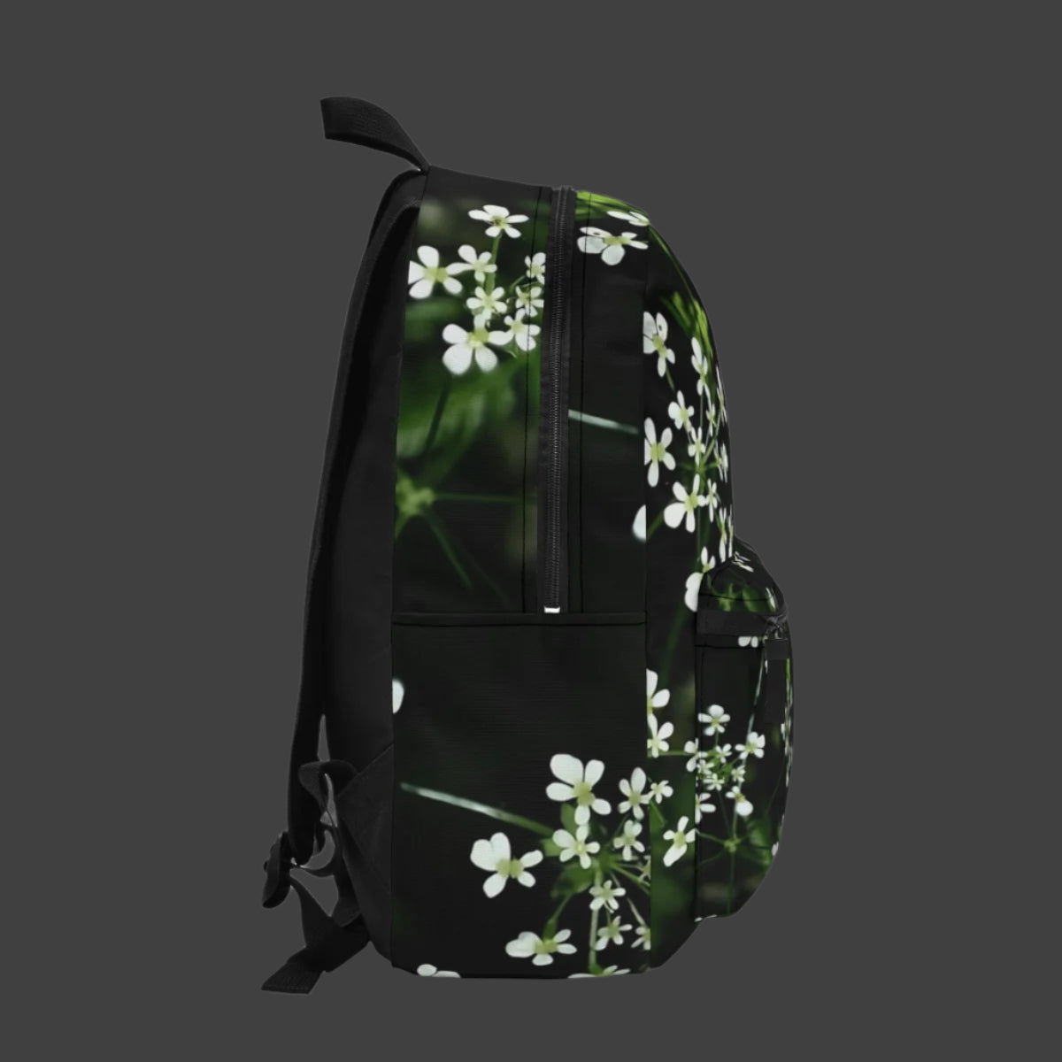 Right side of the backpack with visible bottle pocket and extended white wildflower print blending with natural tones.