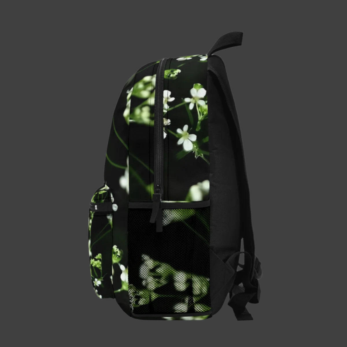 Side view of the full color White Wildflowers backpack, showing the floral design wrapping gently around the side panel.