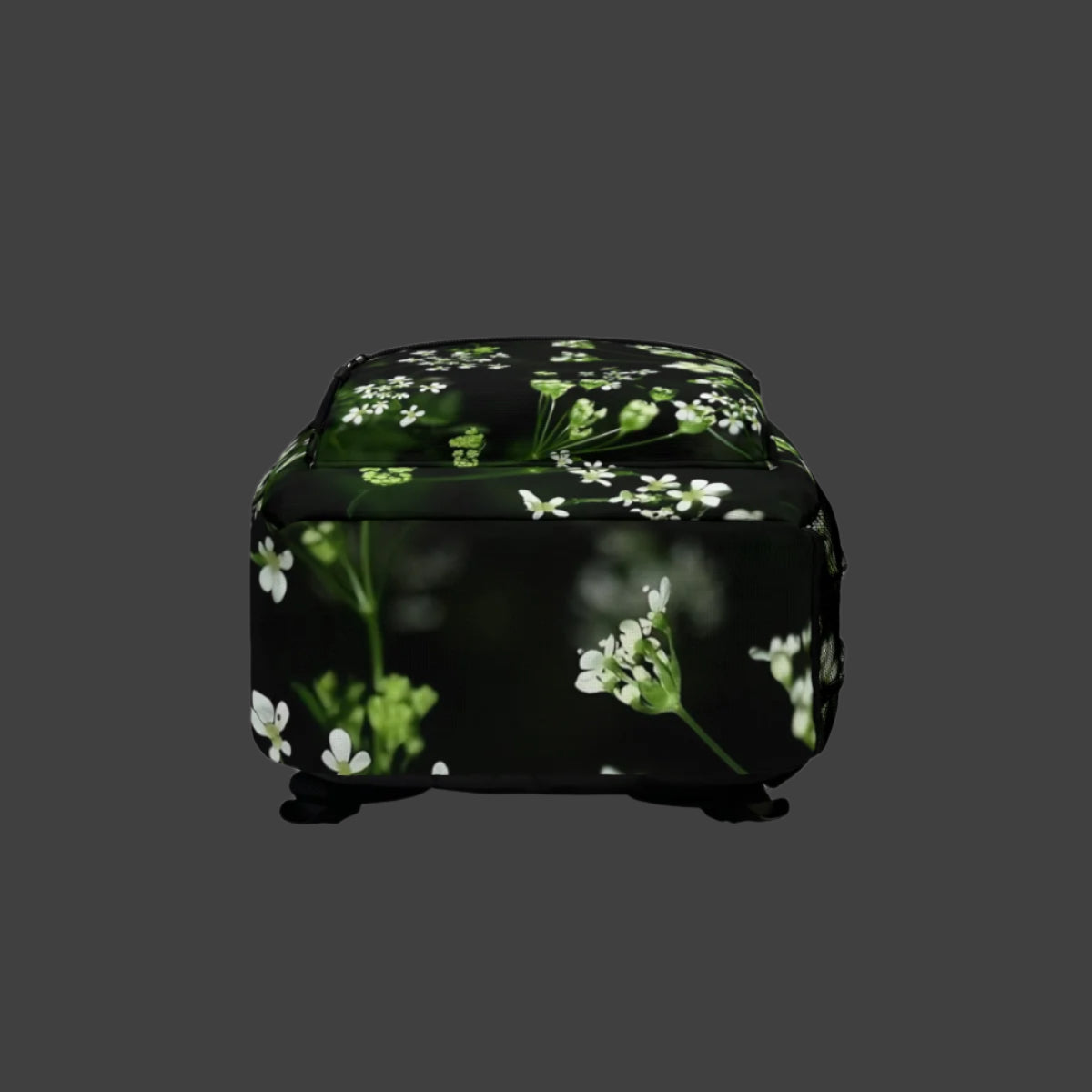 Bottom of the backpack in matching soft tones, showing the continuation of the white wildflower design across the base.