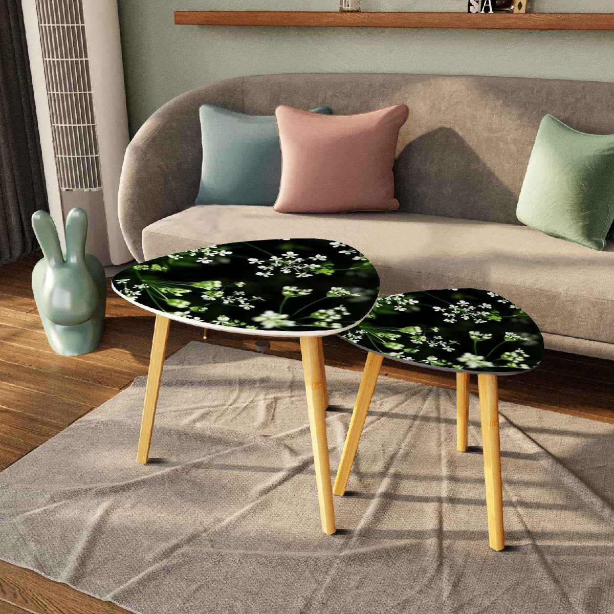 set of 2 floral triangular coffee tables featuring white little flowers on black background with green stems emerging from it