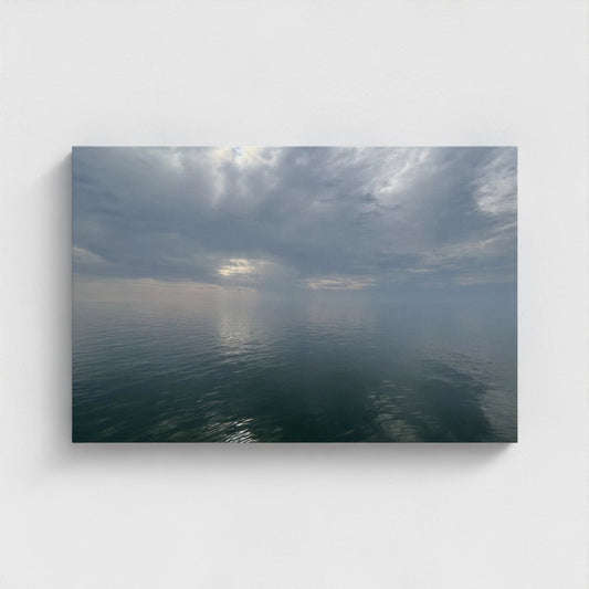 24''x16'' side-angle of eco-friendly sustainable canvas art featuring a tranquil sea mirroring fluffy clouds