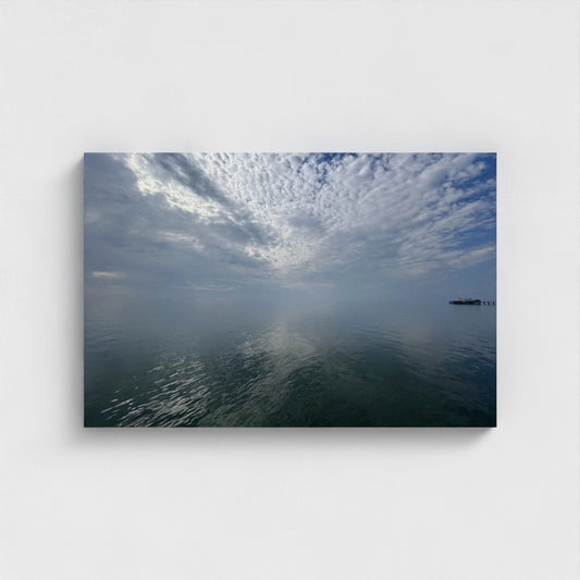 front view of Eco-friendly canvas print of Blackpool seascape with layered clouds, calm water reflections, and a distant pier under a quiet sky.