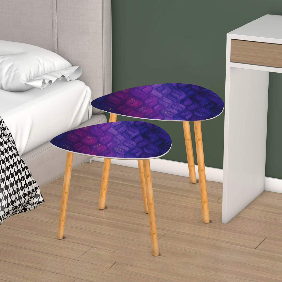 Pair of nested triangle tables with purple-gold leather tabletops arranged on a white rug in front of sheer curtains; bamboo legs rest on wood flooring