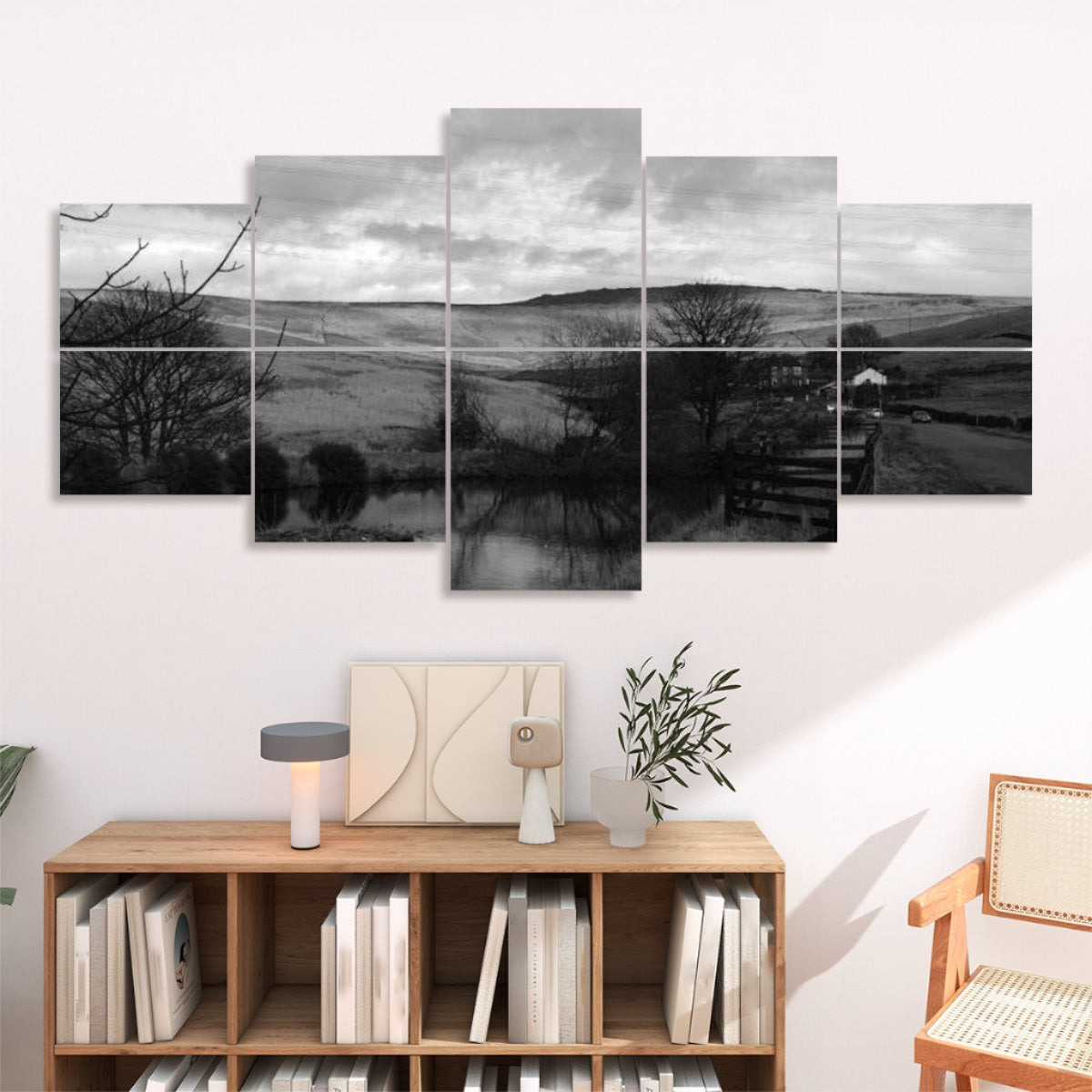Grayscale version of rural landscape with a road, hills, and water reflection arranged on 10 sound absorbing wall panels in muted tones.