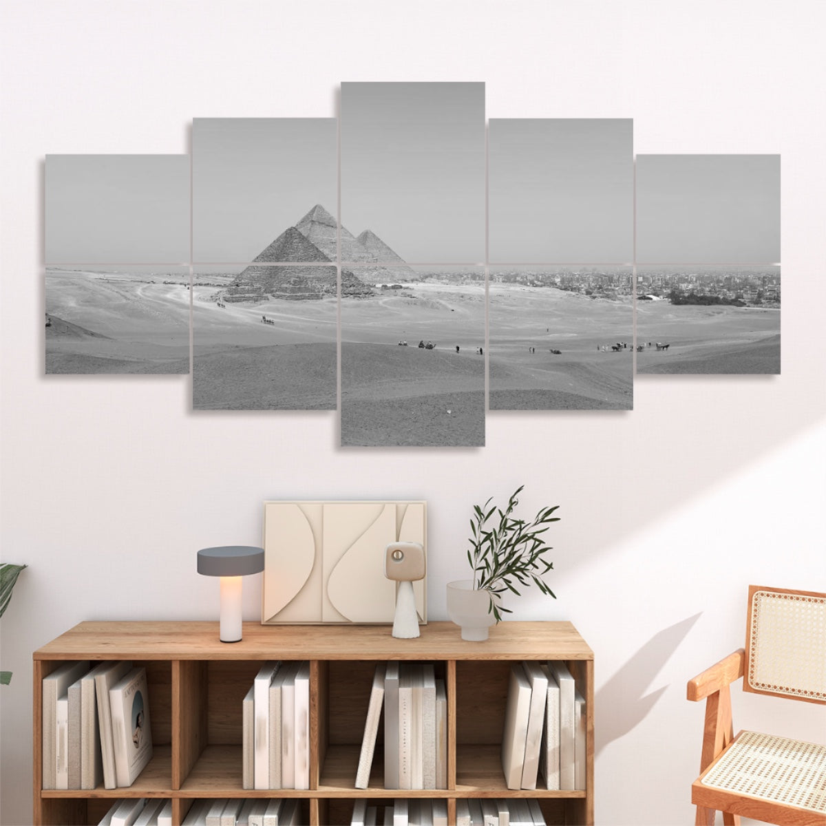 Grayscale version of a wide desert scene with pyramids and scattered figures, displayed across 10 sound absorbing wall panels.