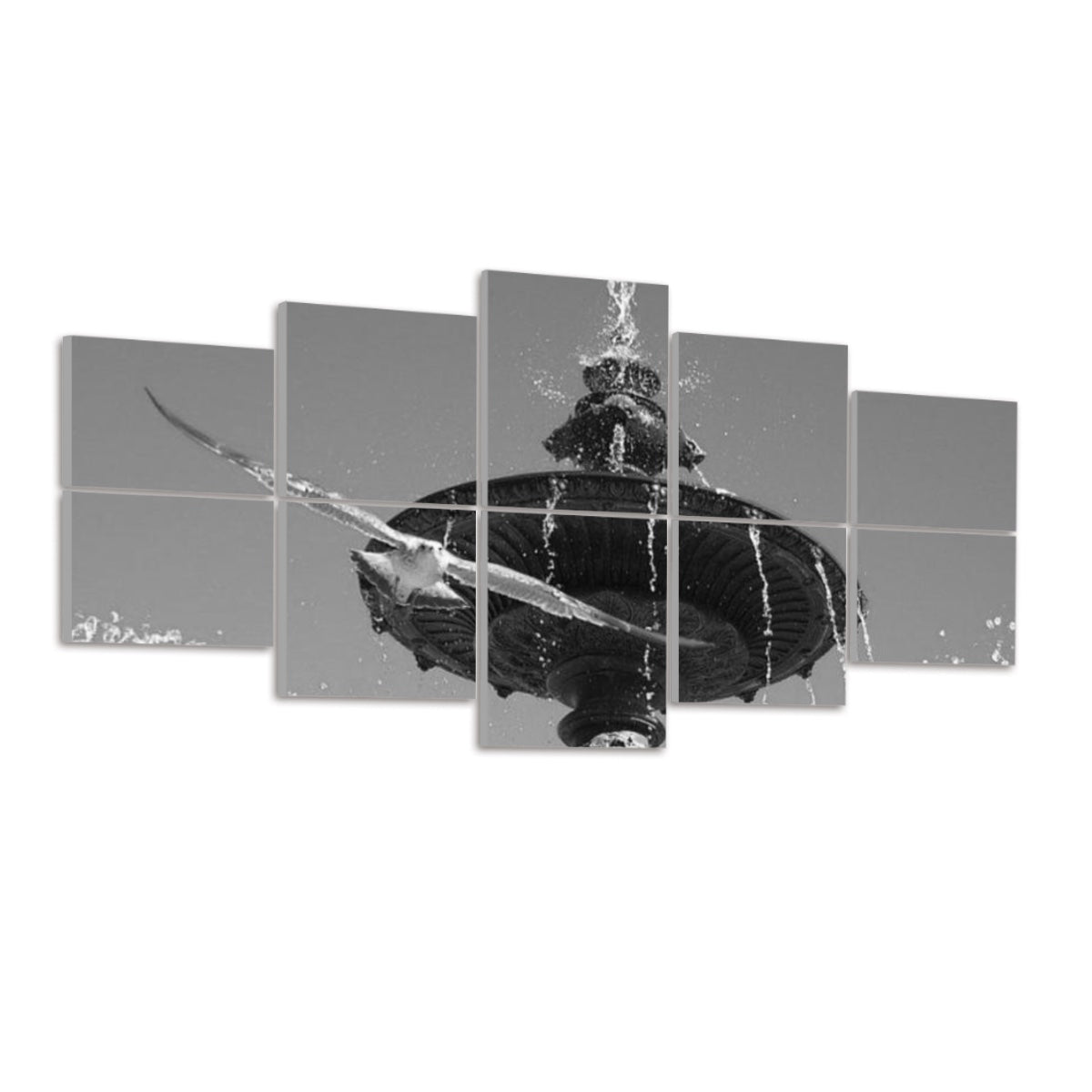 Ten panels on a white wall showing the Lisbon fountain and seagull in black-and-white. The fountain’s carved details and cascading water appear in varying gray tones, while the bird’s form is a dark silhouette against a light gray sky