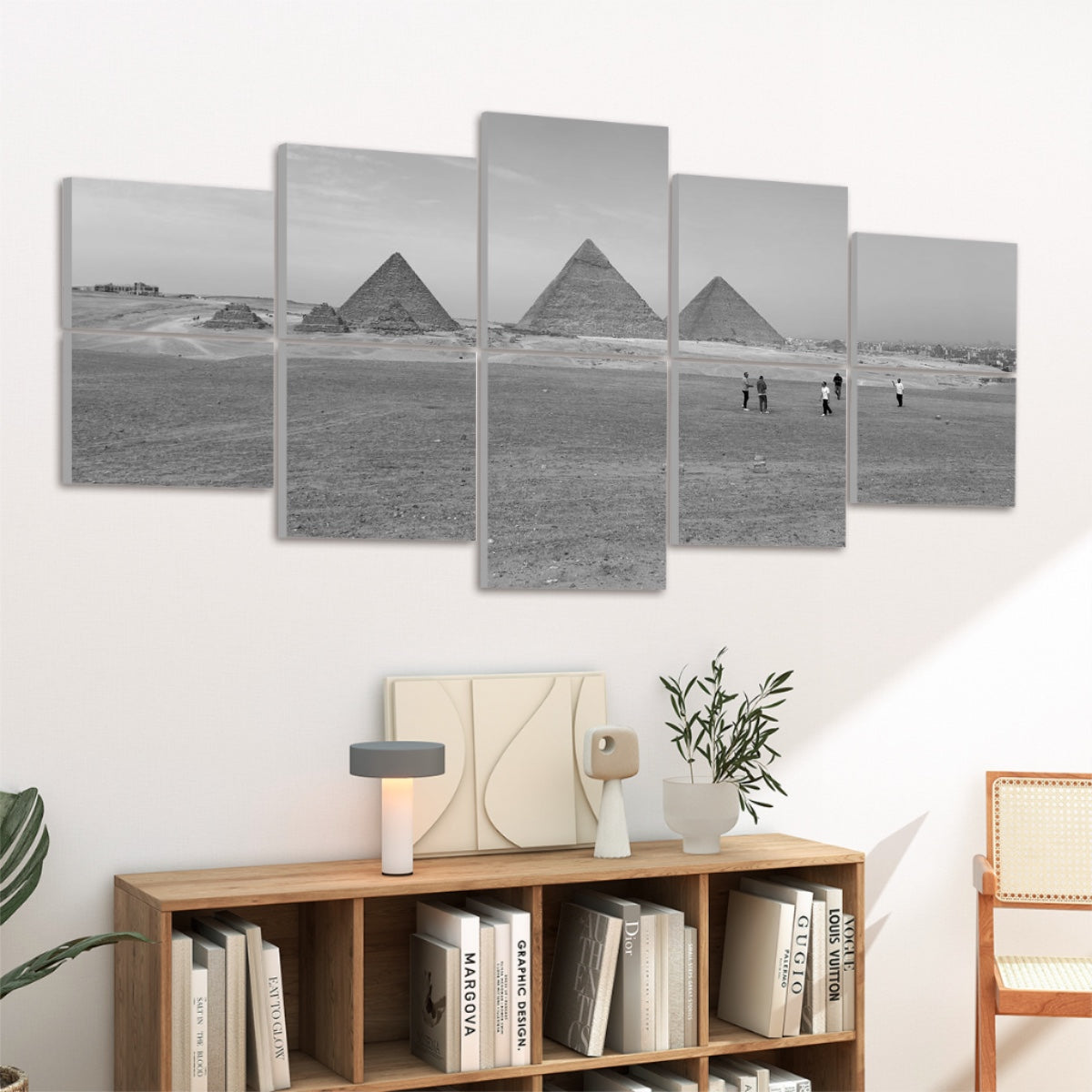 Grayscale depiction of the Giza pyramids in a calm desert setting under a soft sky