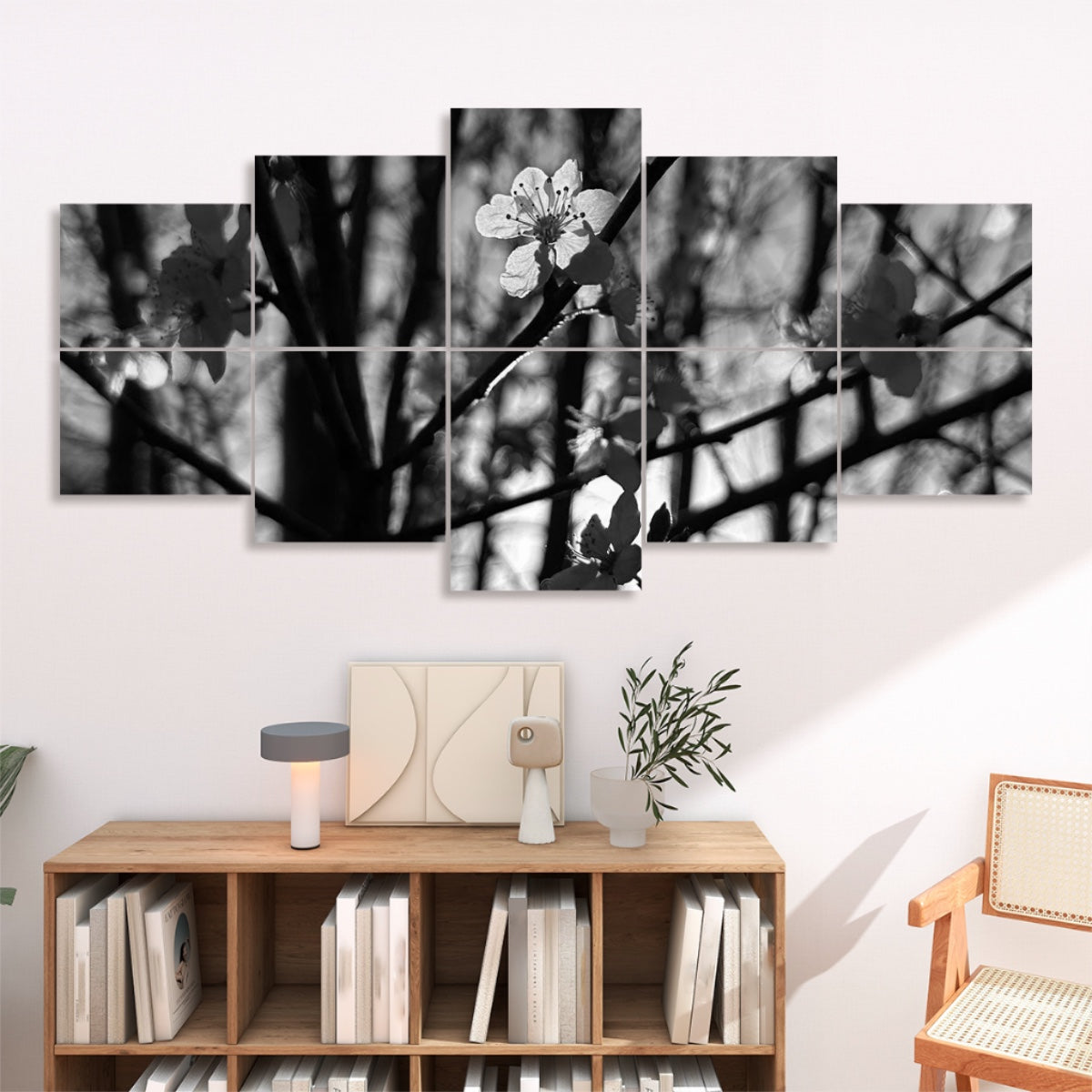 Grayscale version of backlit white blossoms with tree branches and soft light, divided over 10 floral acoustic wall panels in muted tones.