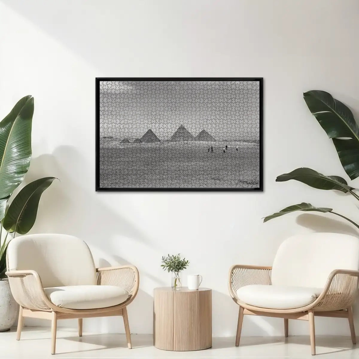 Greyscale image of the Pyramids of Giza with surrounding desert and skyline, showing tonal contrasts and historic texture.