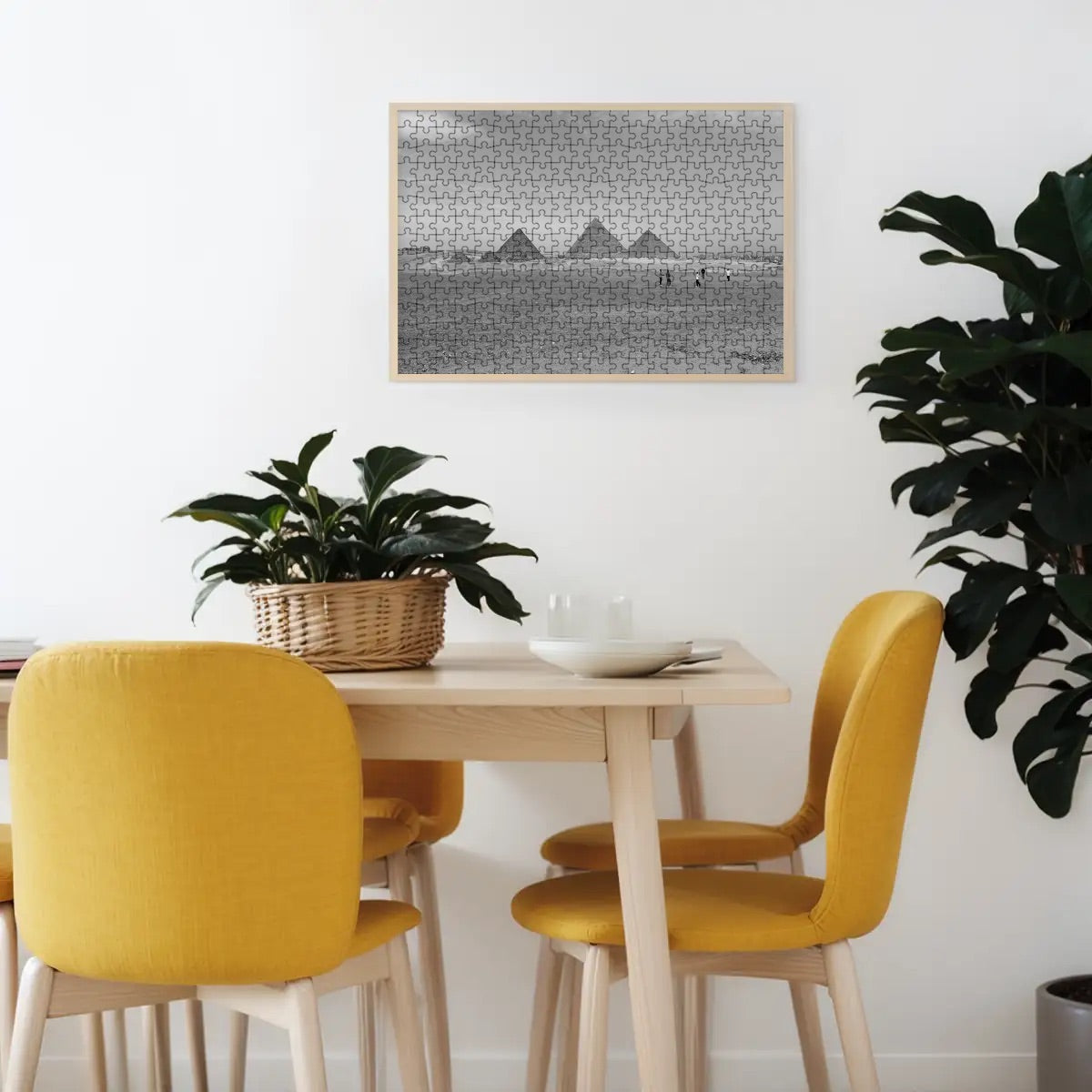 Greyscale photograph of the Pyramids of Giza with textured desert and horizon tones.