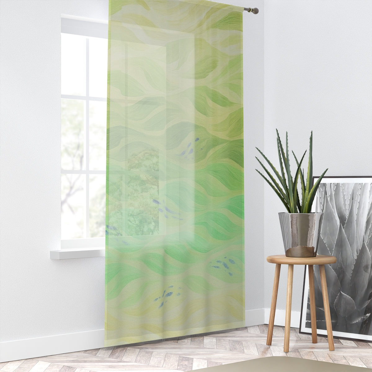 A light-diffusing curtain in pale yellow to vivid chartreuse swirls, the fresh color palette reminiscent of spring foliage, hanging against a crisp white wall; a wooden stool with a potted succulent sits beside it