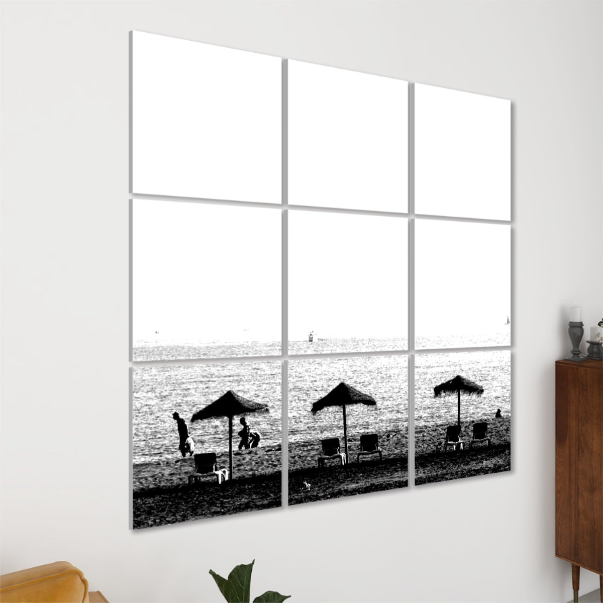 Left angle view of the black and white seaside design with parasols, figures, and a calm ocean horizon, arranged over 9 sound absorbing wall panels.
