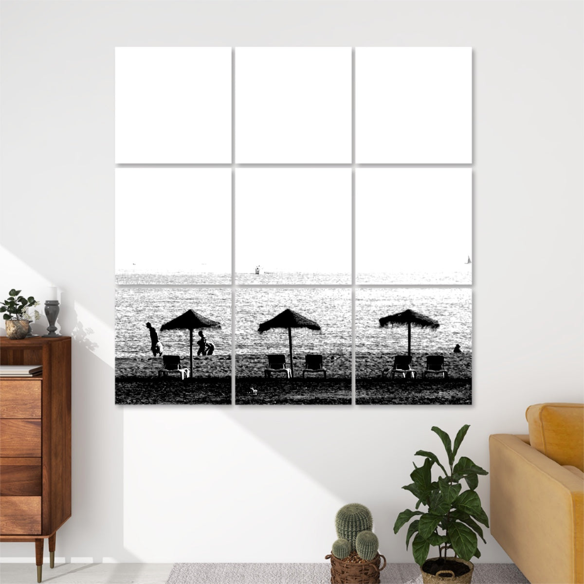 Black and white version of a tranquil beach scene with parasols, chairs, people walking, and sailboats in the distance, arranged across 9 acoustic panels.
