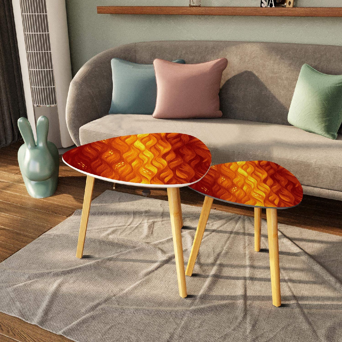 Pair of nested triangles with orange-amber leather tabletops in front of a gray sofa with pastel pillows; bamboo legs rest on a beige rug