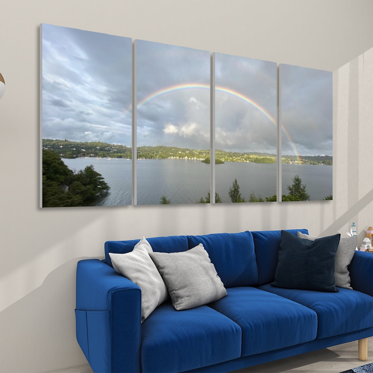4 Decorative Sound Absorbing Panels Featuring Rainbow in Stormy Sky. Wall art above blue sofa showing lake and rainbow