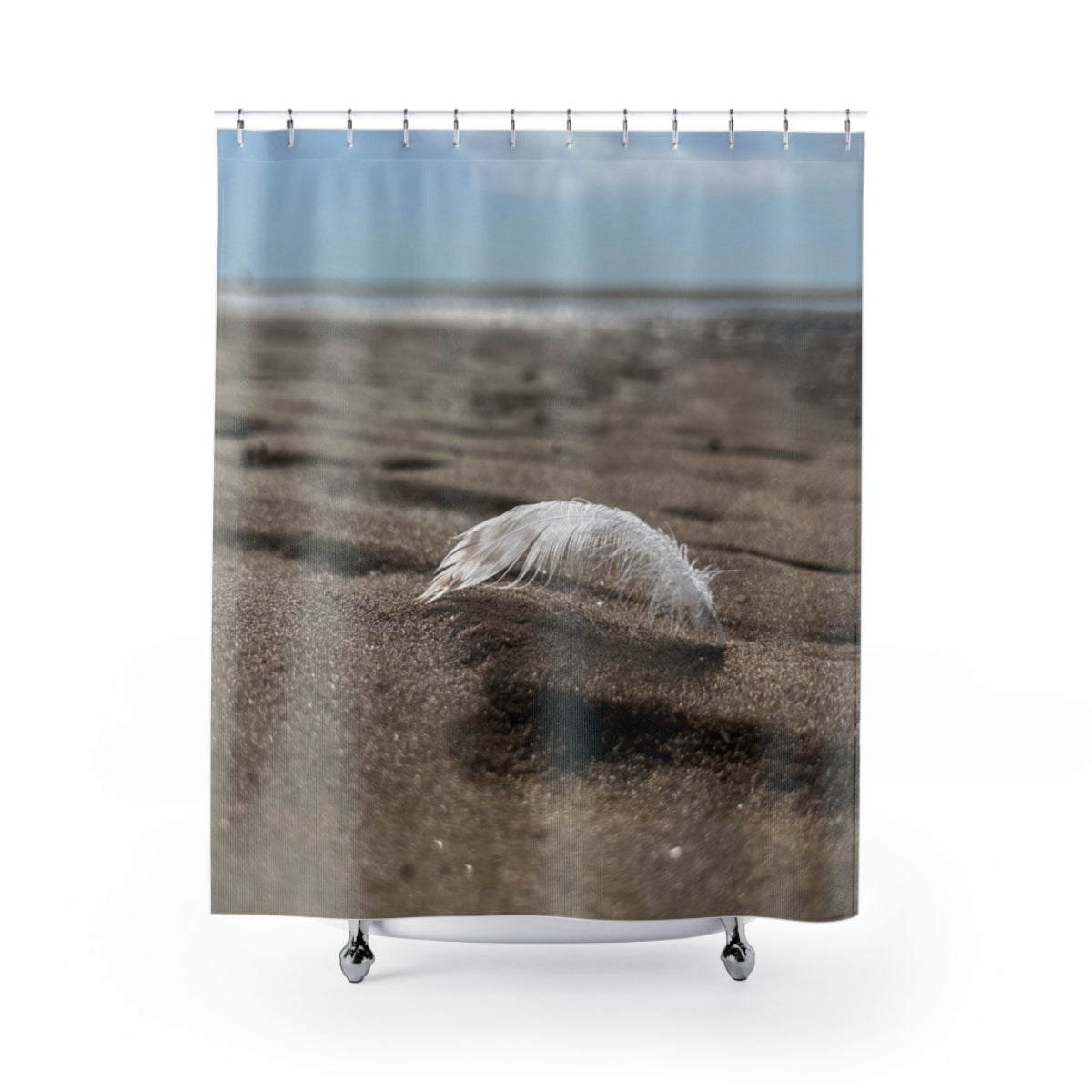 Seaside Feather shower curtain showing a white feather resting on soft-focus sand against a white background