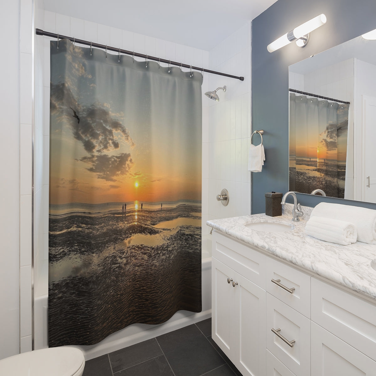 Bathroom mockup with straight rod, showing sunset scene over rippled sand and calm sea next to white vanity