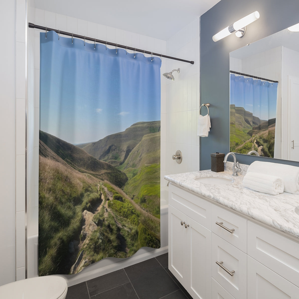 Bathroom vanity mockup with shower curtain hanging on a straight rod, displaying green rolling hills and trail