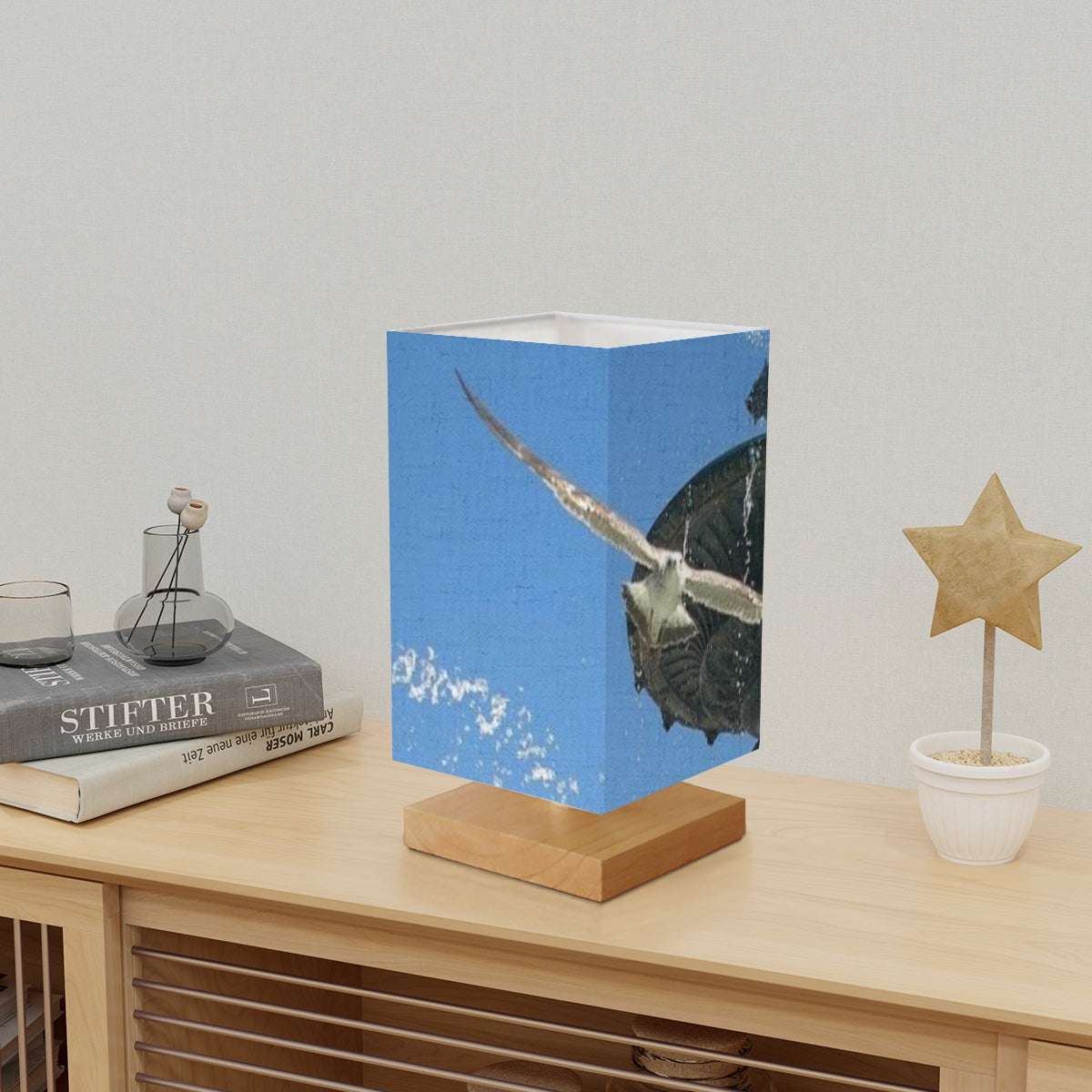 Square Table Lamp featuring picture of seagull in flight with fountain in Lisbon in the background blue sky size: 5.5''x5.5''x11'
