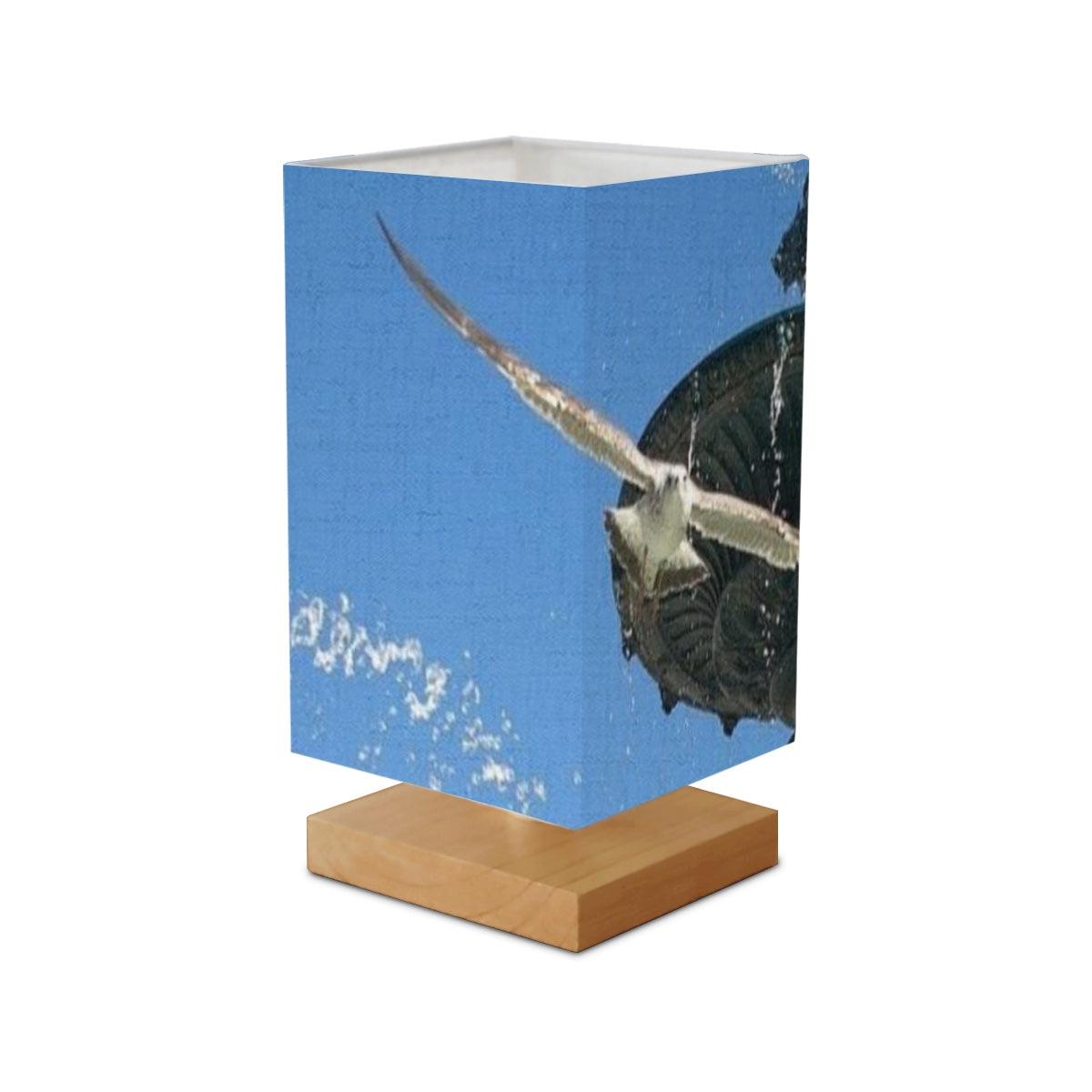 Square Table Lamp featuring picture of seagull in flight with fountain in Lisbon in the background blue sky size: 5.5''x5.5''x11'
