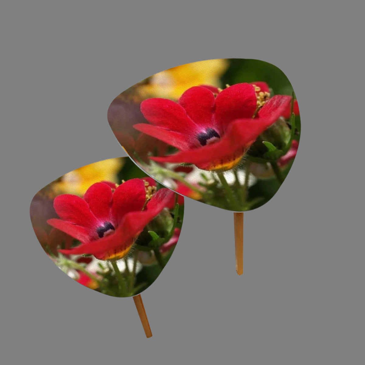 set of 2 triangular coffee tables featuring close up of red flower