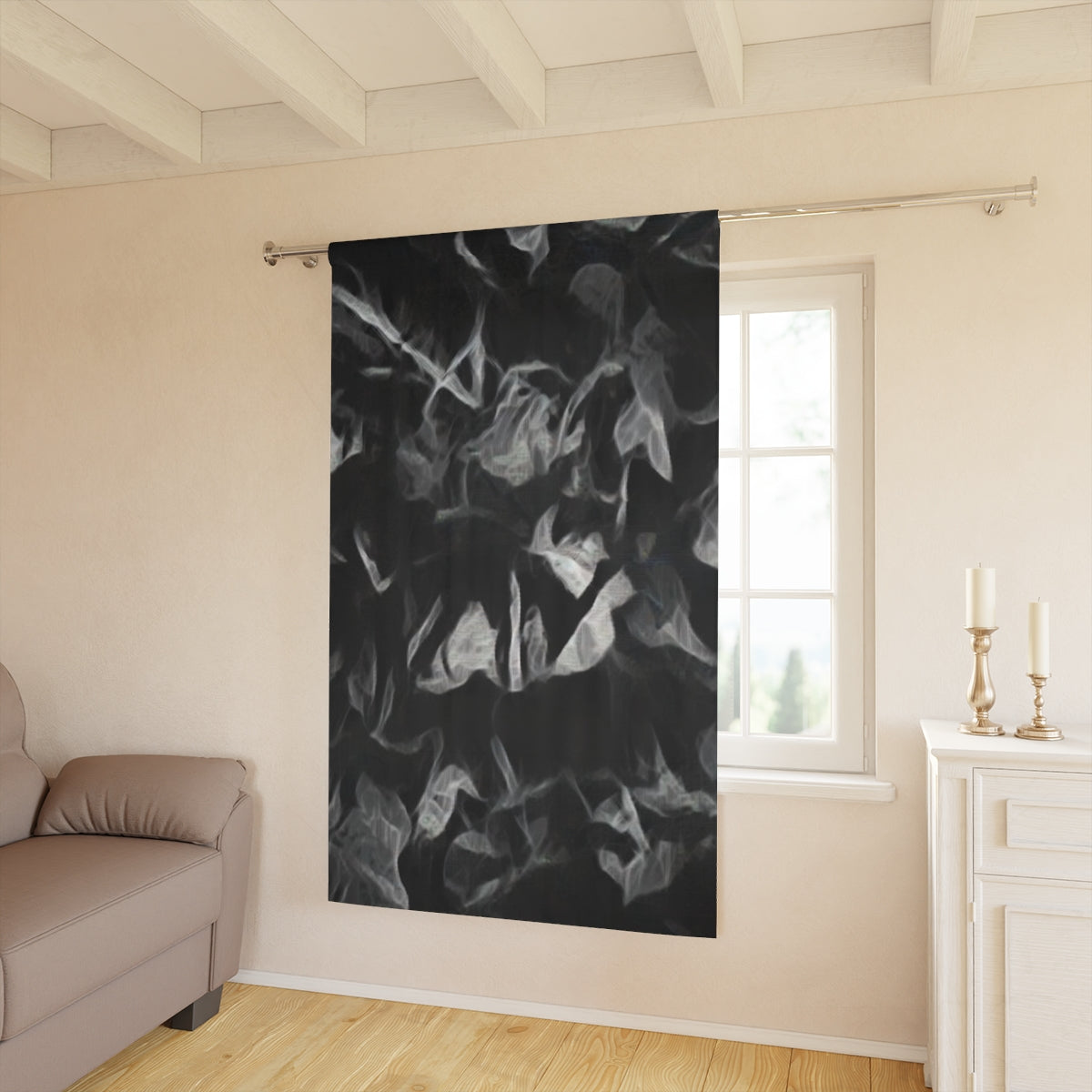 Sonata in Smoke blackout curtain with ghostly white foliage shapes layered over black, adding dramatic depth to a softly lit contemporary room