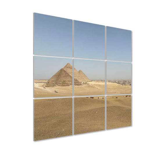Left-side angled view of the full-color Distant Pyramids 9-panel acoustic wall art, showing panel depth and sunlight over desert dunes.