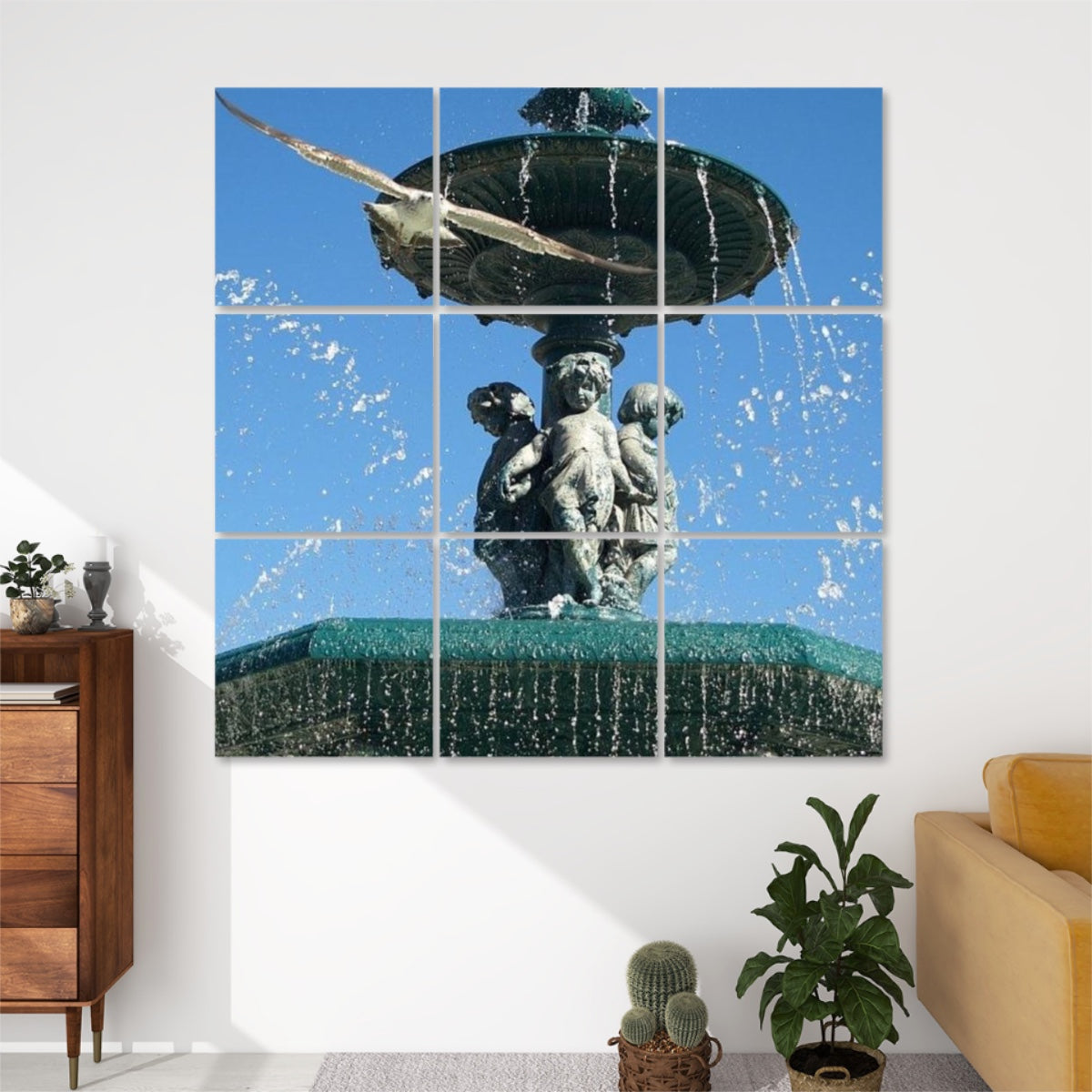 Front view of 9‑panel acoustic wall art showing a seagull flying toward the camera above a Lisbon fountain and blue sky, full color.