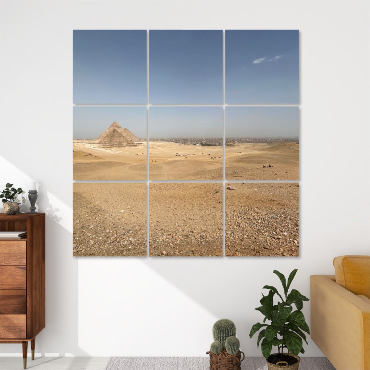 Front view of 9-panel acoustic wall art showing a wide desert landscape with the Pyramids of Giza in the distance under a soft blue sky.