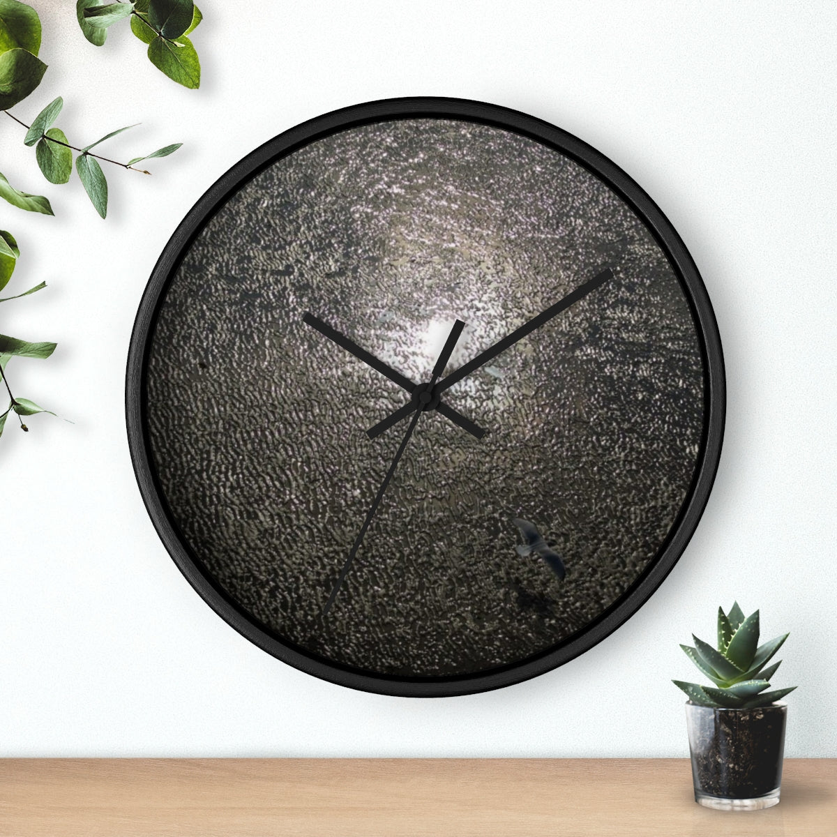 wall clock featuring reflection of sun in the Blackpool beach with seagull flying over it, base: black, handles: black, size: 10''