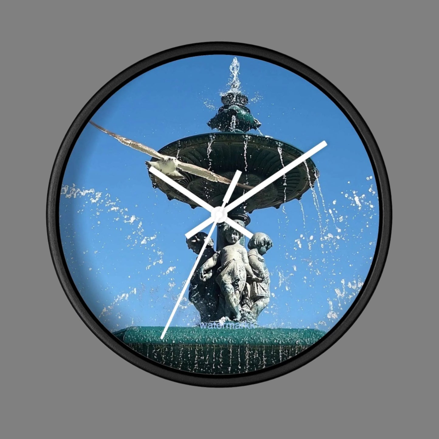 Wall Clock featuring seagull in flight with fountain in Lisbon in background, base: black, handles: white, size: 10''