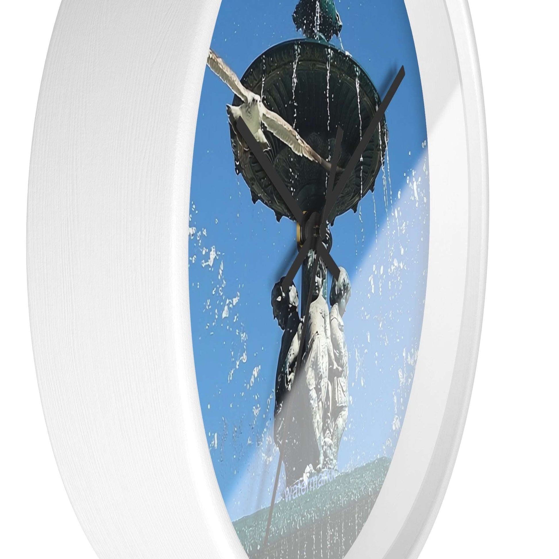Wall ClWall Clock featuring seagull in flight with fountain in Lisbon in background, base: white, handles: black, size: 10''