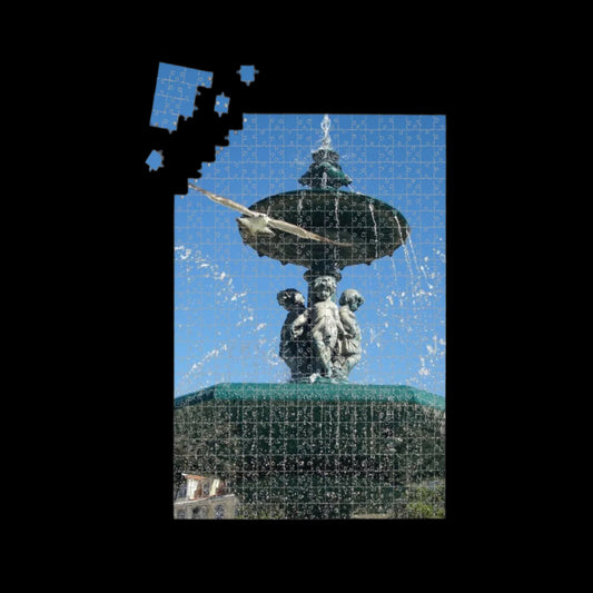 1000-piece oak wood jigsaw puzzle showing a seagull flying toward the camera with a fountain and blue sky in Lisbon, in full vibrant color, size 19.7" x 29.5"