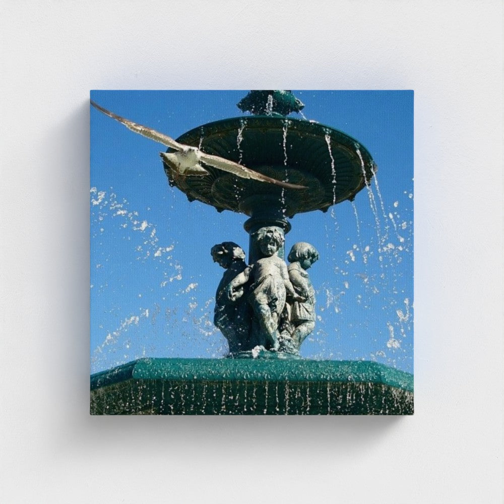 eco-friendly recycled canvas print capturing a frontal view of a seagull in flight above a sculpted fountain with splashing water