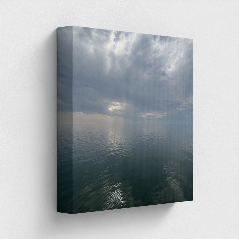 12''x12'' square side-angle of sustainable canvas art print showing soft clouds mirrored in the sea