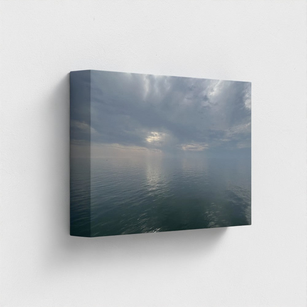 12''x8'' side-angle of sustainable canvas art print showing clouds reflected in still coastal waters
