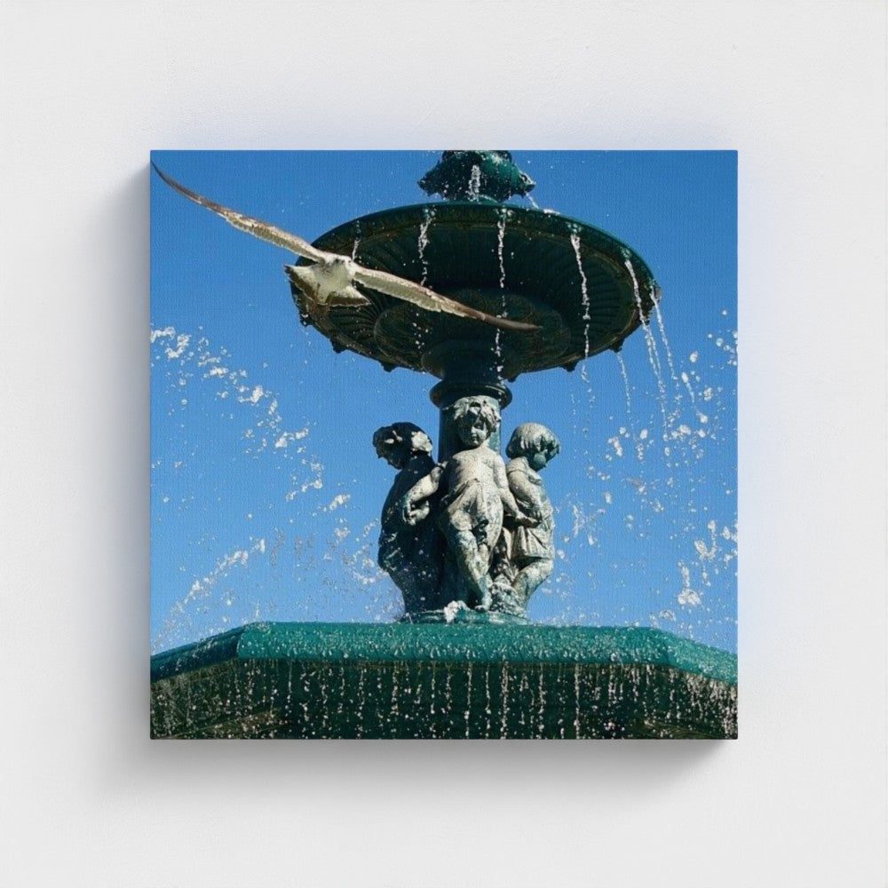 eco-friendly recycled canvas print presenting a square frontal shot of a seagull soaring above an ornate fountain with vibrant sky