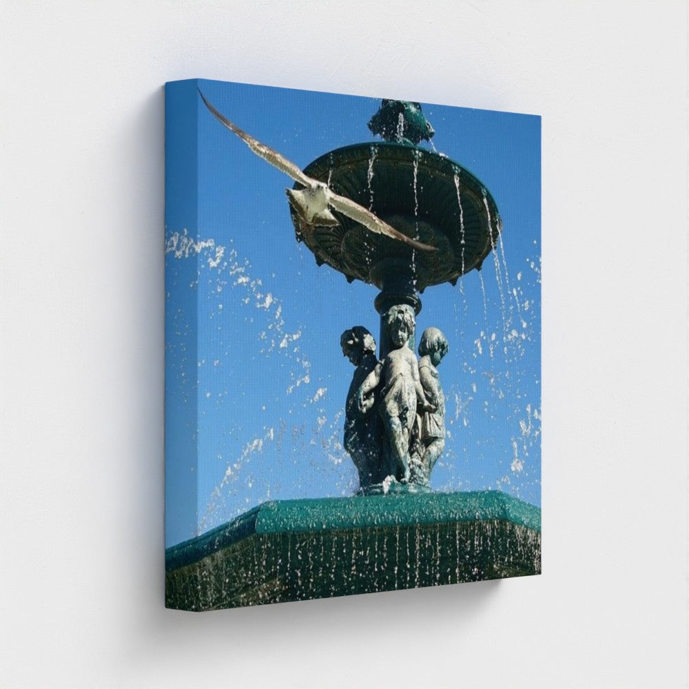 eco-friendly recycled canvas print offering a square side angle of a seagull in flight over a water-sculpted fountain