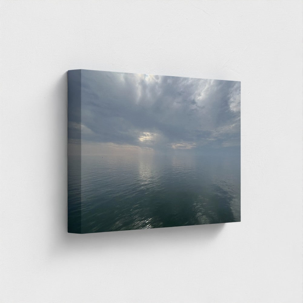 18''x12'' side-angle shot of sustainable canvas art with serene sea reflecting dramatic cloud formations