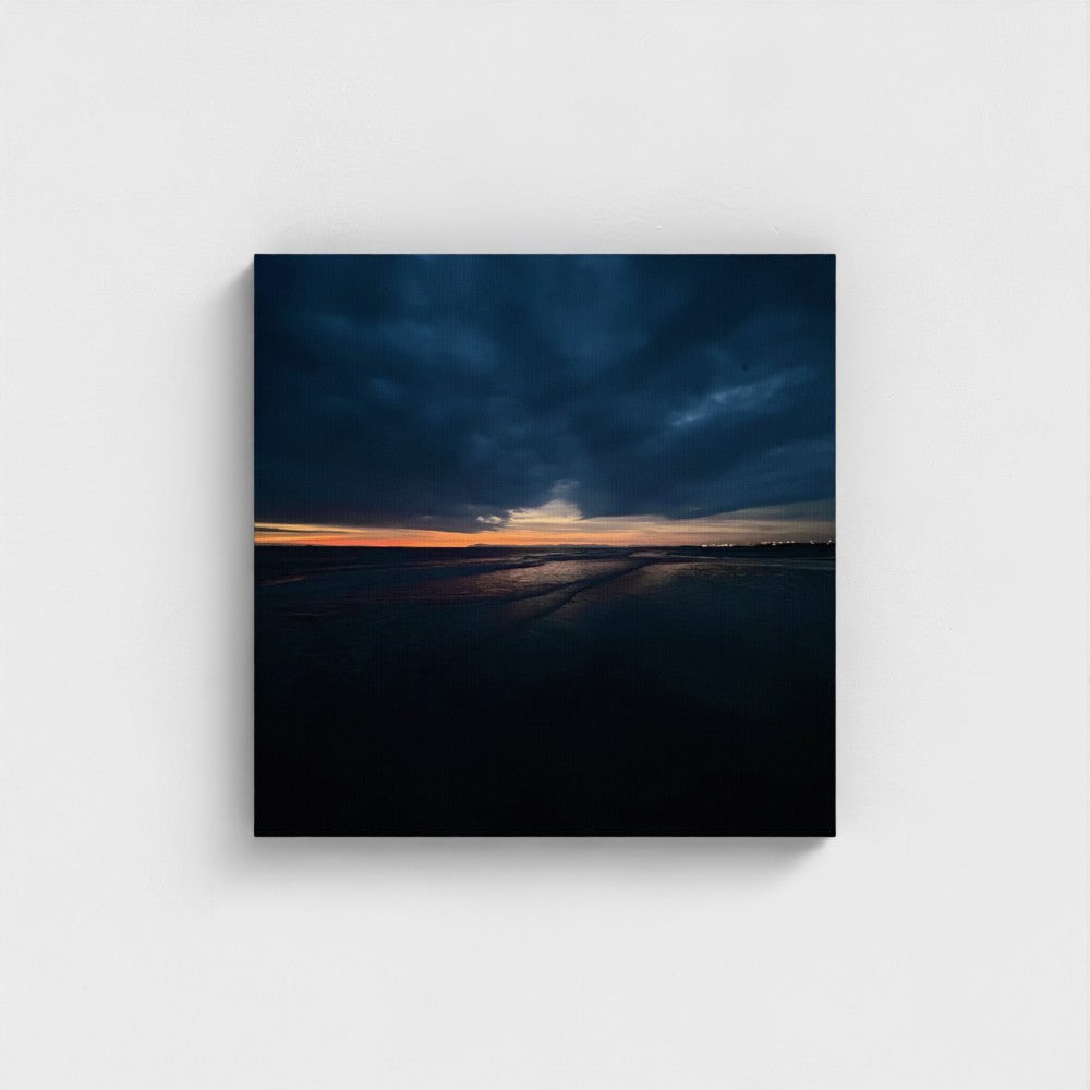Eco Canvas Print Blackpool Beach Sunset, sun sinking behind the Irish Sea with faint silhouettes of beach structures on the horizon