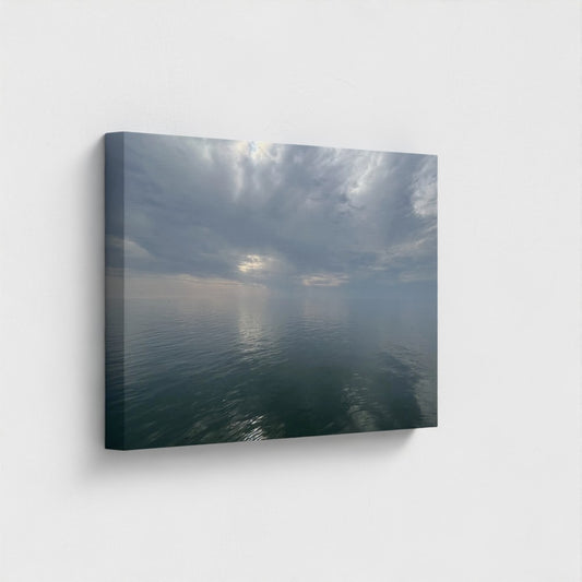 24''x16'' sustainable canvas art featuring a tranquil sea mirroring fluffy clouds